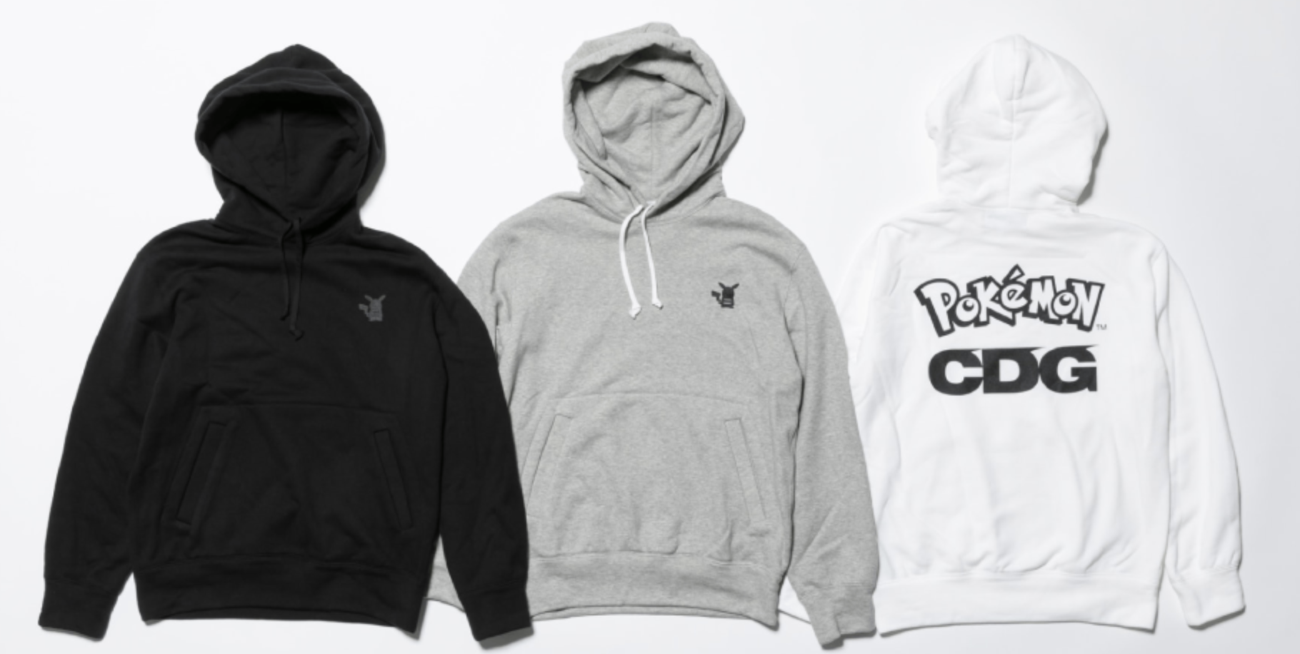 Three CDG hoodies. Black one has a gray Pikachu applique, gray one has a black Pikachu applique. White one has Pokemon and CDG logos