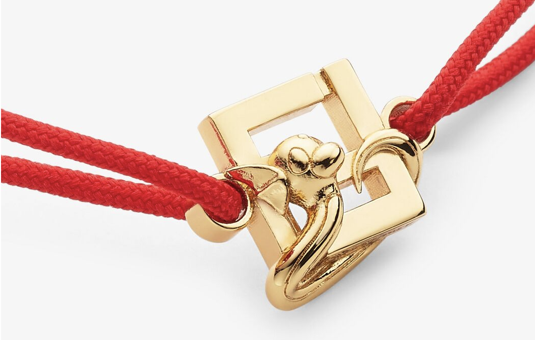 Gold piece with Fendi logo and Dratini coiled around it