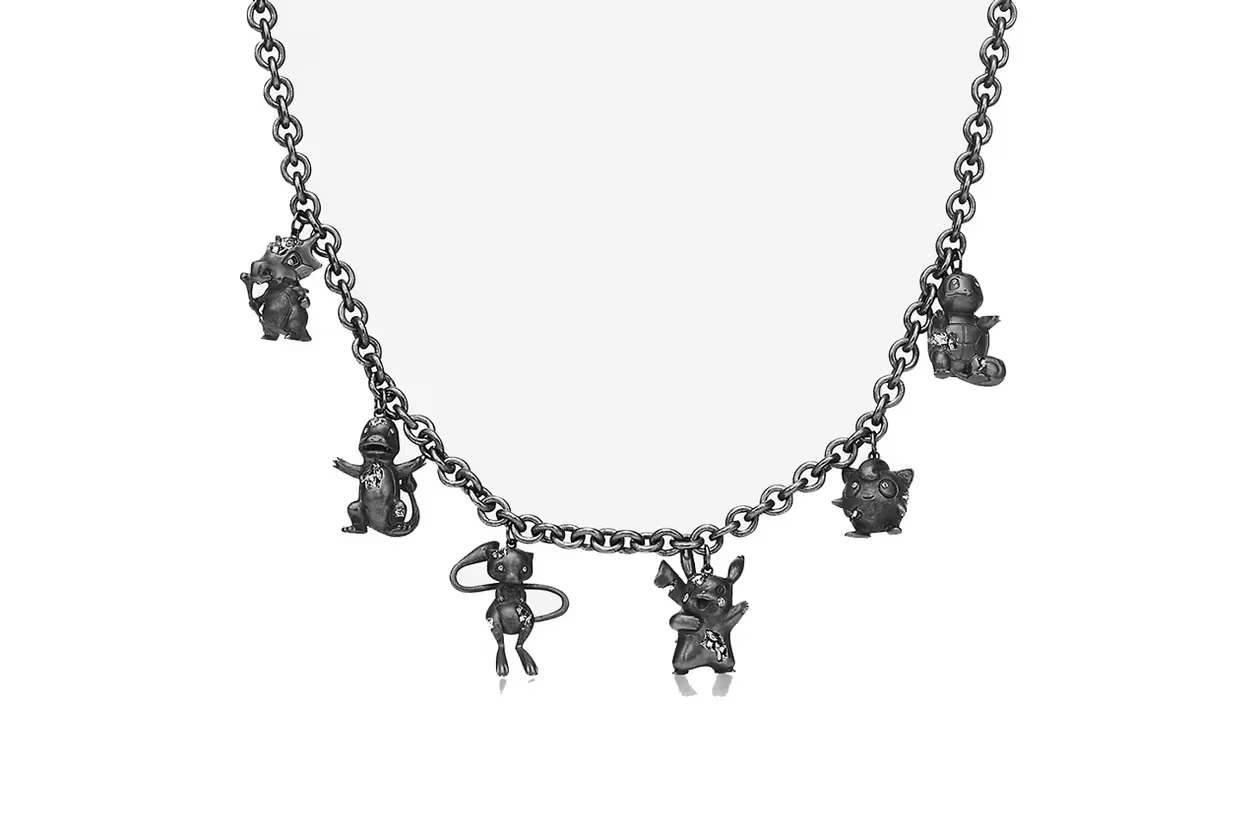A black chain necklace with several charms of Cubone, Charmander, Mew, Pikachu, Jigglypuff, and Squirtle.