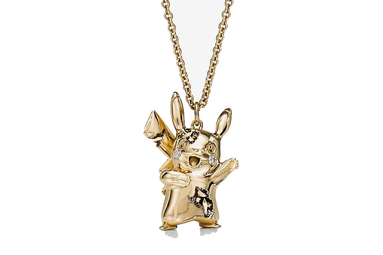 A gold chain with a gold Pikachu charm. The gold Pikachu has its arms raised and has diamonds embedded in it.