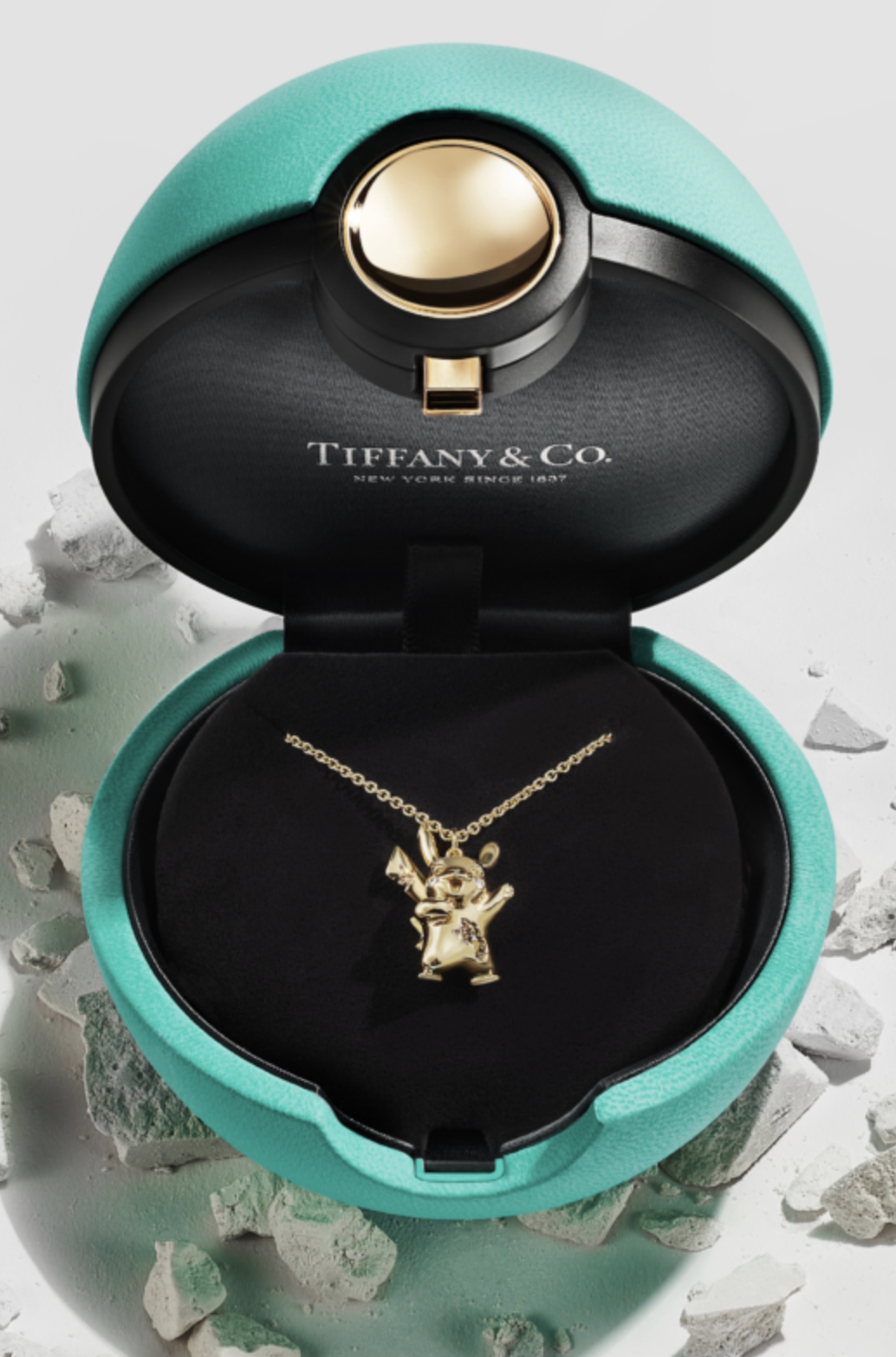 A turquoise Pokeball ring box for the golden Pikachu necklace